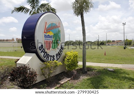 LAUDERHILL, FL, USA - JUNE 19, 2014: Large and colorful entrance sign for the Lauderhill Sports Park in front of a soccer field. The plastic sign also mentions that Lauderhill is an All-American City