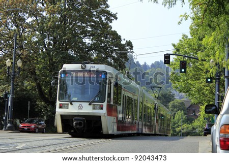 PORTLAND, OREGON - AUGUST 5: Public light rail train passing by during the day on August 5, 2010 in Portland, Oregon. There are 52.4 miles of light rail lines in the Portland metropolitan area.