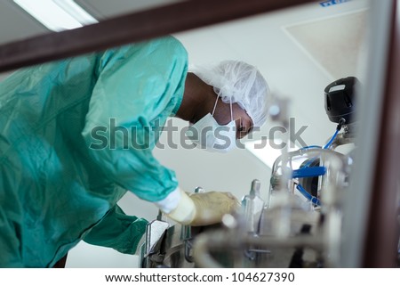Lab technician at work as researcher in biotech industry with precision equipment