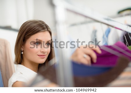 Beautiful girl shopping for clothes and shirt in fashion store