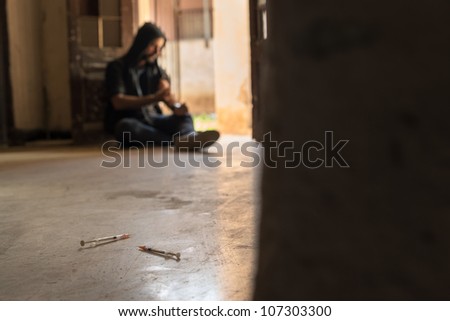 Heroin junkie shooting up drugs with syringe. Low angle view, copy space