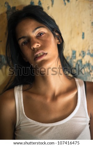Domestic violence, portrait of abused and hurt young woman crying at home