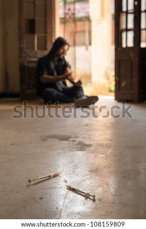 Heroin junkie shooting up drugs with syringe. Low angle view, copy space