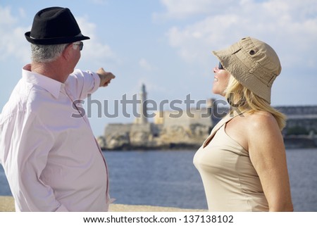 Tourism and active retirement with elderly people traveling, senior couple having fun on holidays in Havana, Cuba