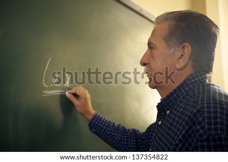 People and education, professor writing on board during lesson in college, Law School, University of Havana, Cuba