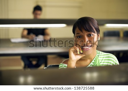 College library and female student, young african american woman studying at university