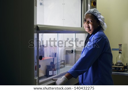 Medical research center and industrial facility, woman cleaning test tubes in laboratory
