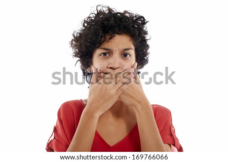 hispanic woman with hands covering mouth, speachless and angry, looking at camera
