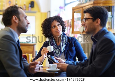 People at bar with team of colleagues meeting in cafeteria, working with  and drinking coffee