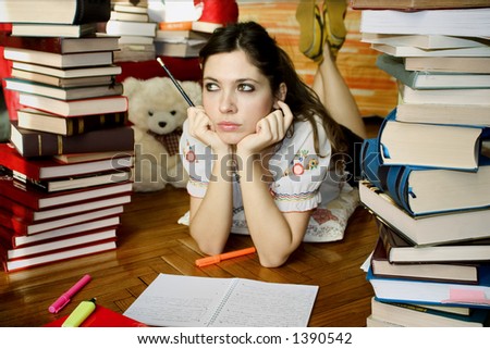 Girl studying surrounded by books