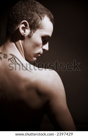 stock photo man seen from behind showing his tattoo on his shoulders