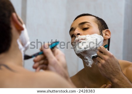 morning routine: a man shaving before going to work