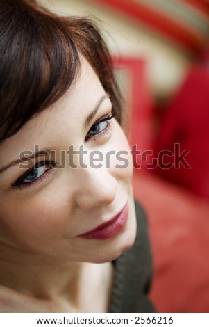 day dreaming: charming woman smiling and looking at the camera