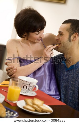 healthy living: young couple having breakfast at home