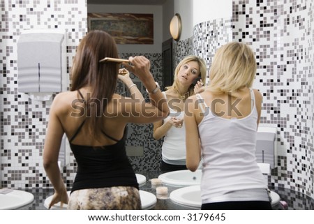 stock photos girls night out. stock photo : girls night out: girls applying makeup in the bathroom of a 