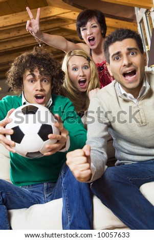domestic life: group of friend watching soccer on tv