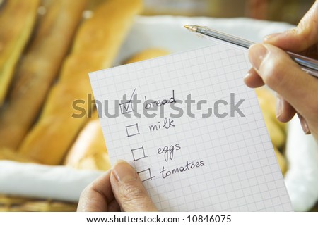 woman in a supermarket checking his shopping list