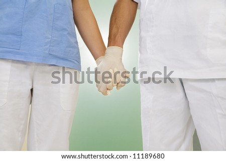stock photo : doctor and nurse holding hands in the hospital