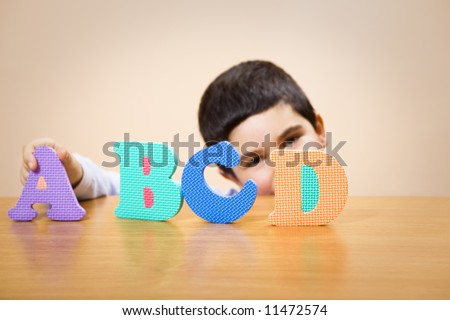 child learning the ABC\'s. The focus is on the letter D. Some copy space