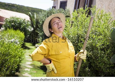 Tired senior Italian woman having backache while gardening