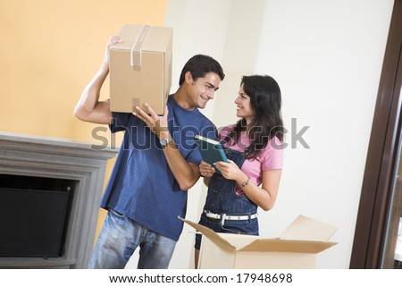stock photo : Young happy couple moving boxes at home