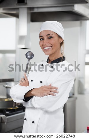 portrait of female chef looking at camera in kitchen