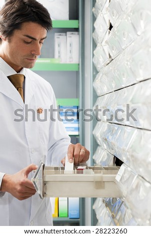 pharmacist taking medicine from drawer. Copy space