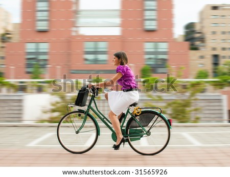 mixed-race businesswoman going to work by bike.