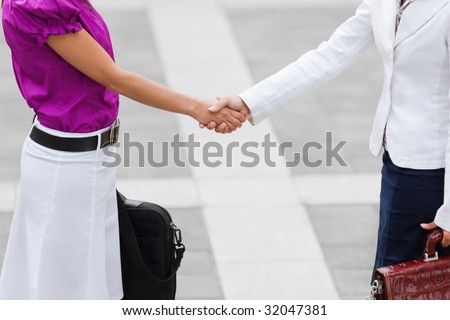 cropped view of two business women shaking hands. Copy space