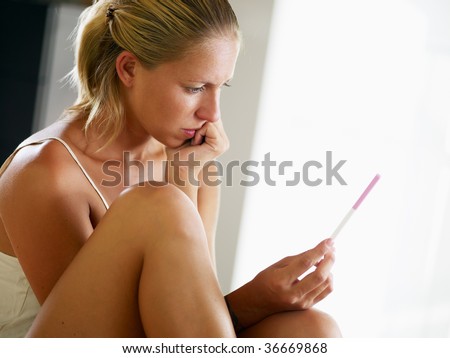 woman looking at pregnancy test. Side view, Copy space