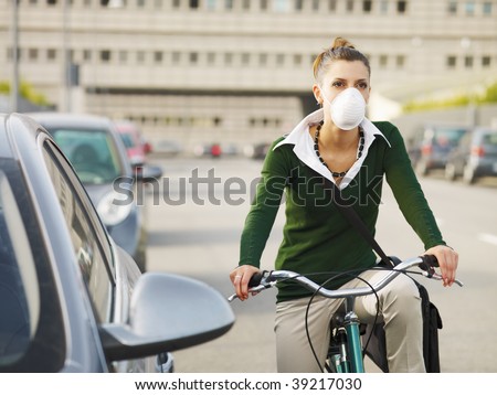 woman with dust mask commuting on bicycle