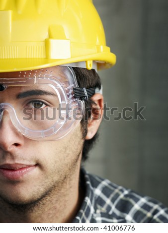 Construction worker with goggles looking at camera. Copy space