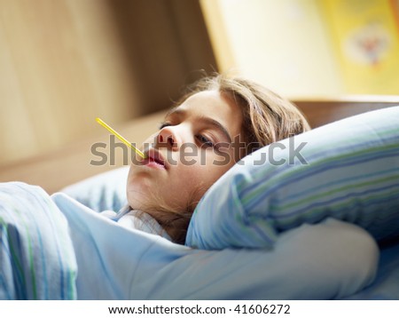 girl taking temperature in bed. Copy space