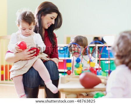 female toddler and 2-3 years girls playing with toys in kindergarten. Horizontal shape, copy space
