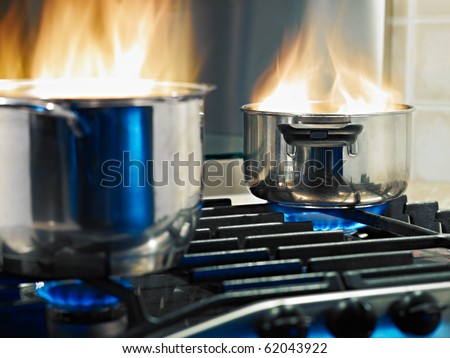 pans in fire on stoves. Horizontal shape