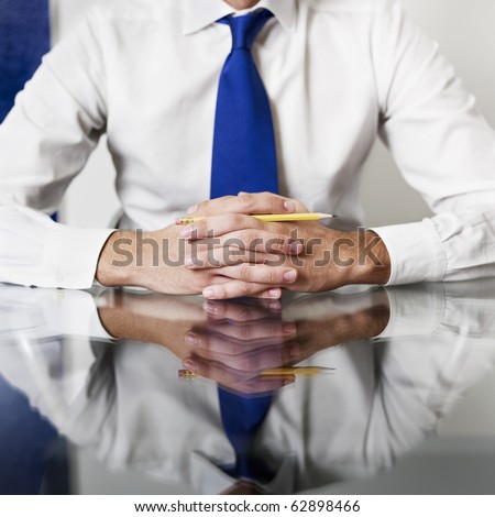 cropped view of businessman with hands clasped. Square shape, front view