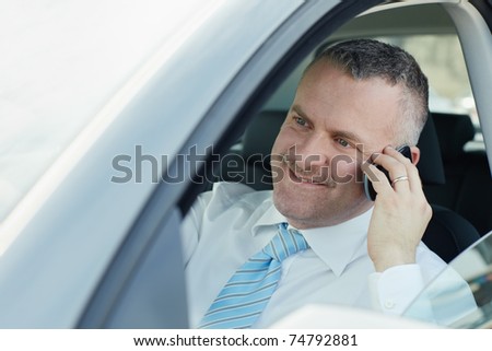 mature caucasian business man calling on the phone and smiling. Horizontal shape, side view, head and shoulders