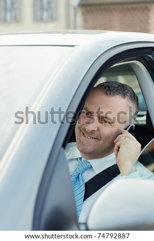 mature caucasian business man calling on the phone and smiling. Vertical shape, side view, head and shoulders
