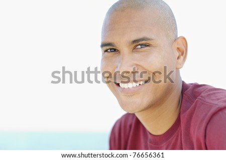 stock photo portrait of young hispanic guy with shaved head looking at 