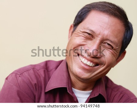 stock photo Portrait of happy mature Asian man smiling and looking at 