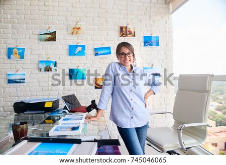 Young people, entrepreneur and small business. Portrait of happy young woman at work as photographer in studio. Confident girl smiling, looking at camera. Artist and art profession.