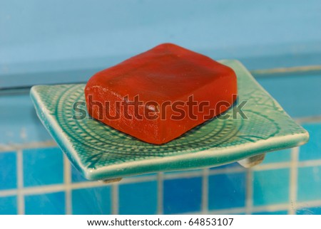 A soap on a soap-dish in a bathroom.