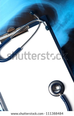 Empty clipboard with a stethoscope and Xray photo