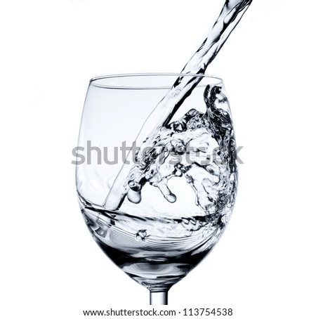 Pouring water into glass (splash of water) isolated