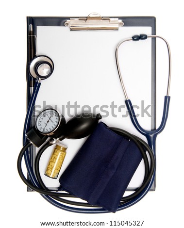 Empty document in a clipboard with a stethoscope, pills and sphygmomanometer