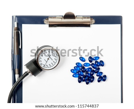 Empty document in a clipboard with pills and sphygmomanometer isolated on white