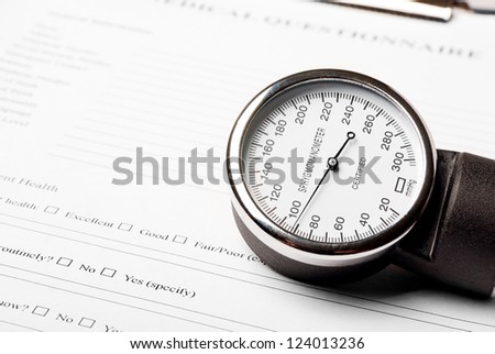 Sphygmomanometer on medical document (medical questionnaire)