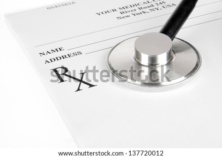 Empty medical prescription with a stethoscope isolated on white background