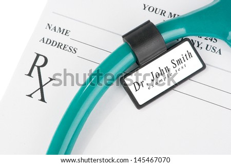 Stethoscope with medical ID tag on empty prescription isolated on white