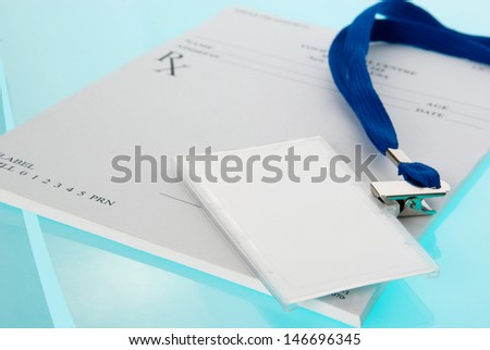 Empty medical identification tag with stethoscope on medical prescription and blue background
